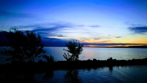 Scenic view of lake against sky during sunset