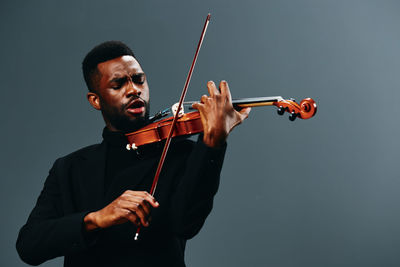 Low angle view of violin against white background