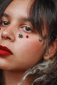 Close-up of woman with insect on face