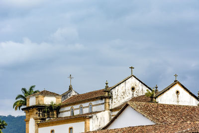 Low angle view of ancient church roof against sky