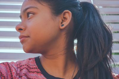 Close-up of young woman looking away