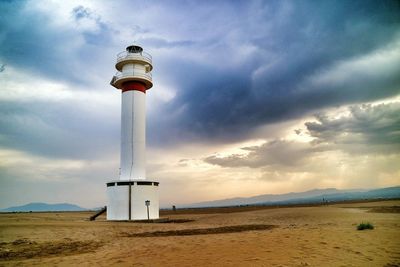 Lighthouse against cloudy sky