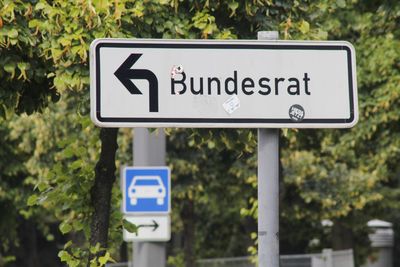 Information sign against trees