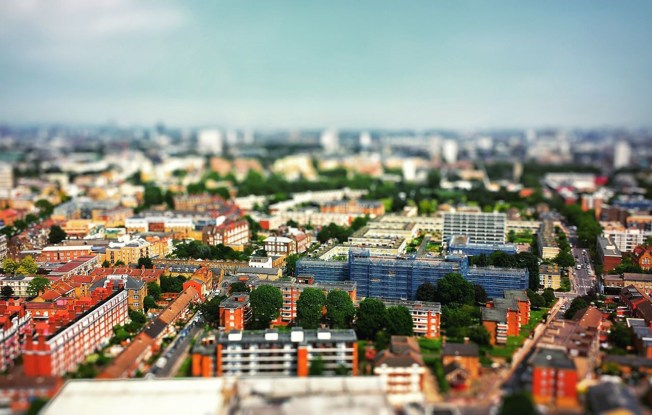 cityscape, building exterior, architecture, city, built structure, crowded, high angle view, residential district, focus on foreground, selective focus, residential structure, residential building, sky, clear sky, day, city life, outdoors, roof, no people, aerial view