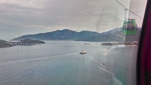 Boats sailing in sea against sky