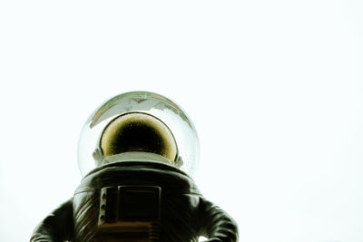 Low angle view of glass bottle against white background