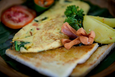 Close-up of meat and bread on plate