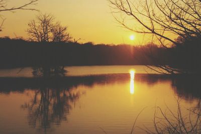 Scenic view of lake at sunset