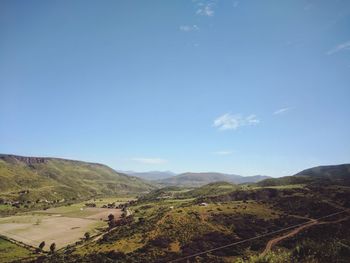 Scenic view of landscape against blue sky