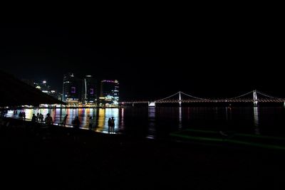 Suspension bridge over river at dusk