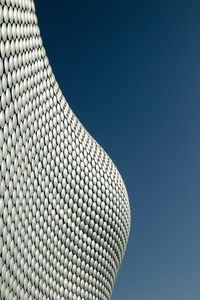 Low angle view of modern building against clear blue sky