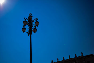 Low angle view of gas light against clear blue sky