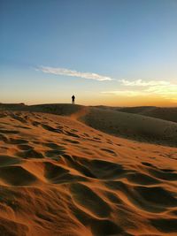 Scenic view of desert against sky during sunset