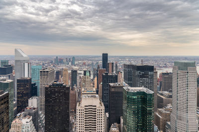 High angle view of modern buildings in city against sky