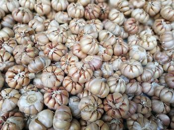 Full frame shot of garlic bulbs for sale in market