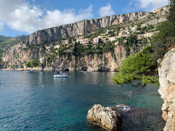 Scenic view of sea and mountains against sky