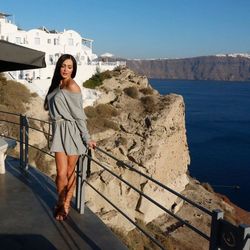 Full length of beautiful woman standing at observation point by sea