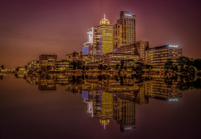 Reflection of buildings in water at night