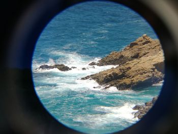 Close-up of sea against sky seen through window