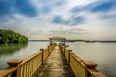 Pier over lake against sky