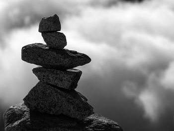 Low angle view of stone stack against sky