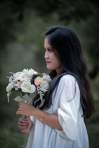 Young woman holding bouquet