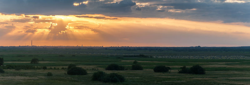 Scenic view of field against sky during sunset