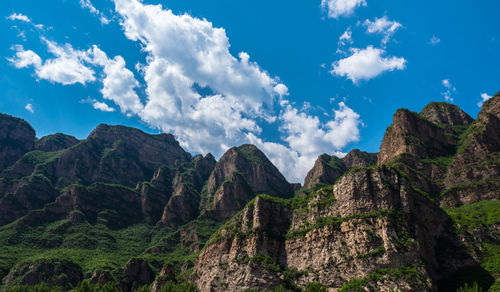 Scenic view of mountains against blue sky