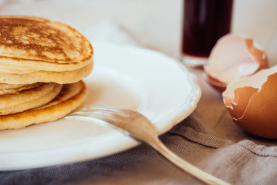 Close-up of pancakes served in plate on table