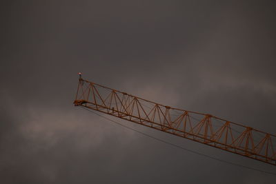 Low angle view of crane against sky