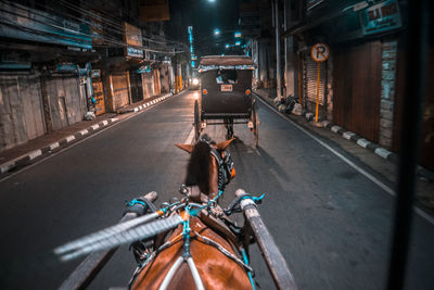 Man riding motorcycle on road at night