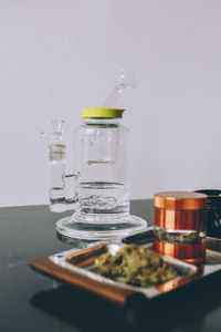 Close-up of on cannabis plant and grinder on table