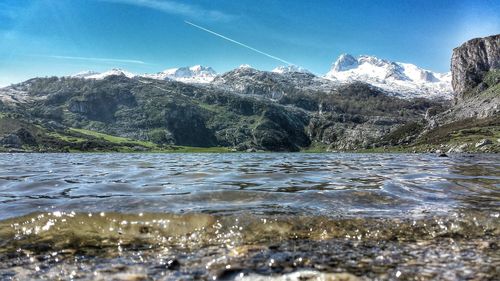 Scenic view of lake and mountains against sky