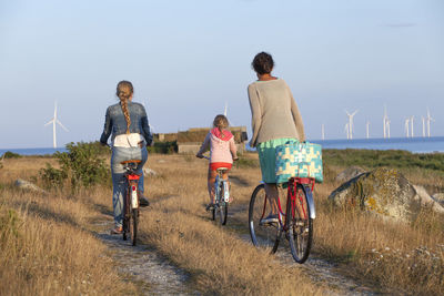 Mother with daughters cycling, oland, sweden