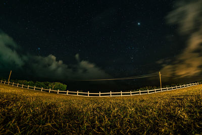 Scenic view of field against sky at night