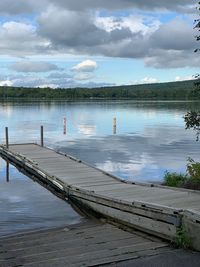 Pier on lake against sky