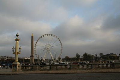 Ferris wheel against cloudy sky