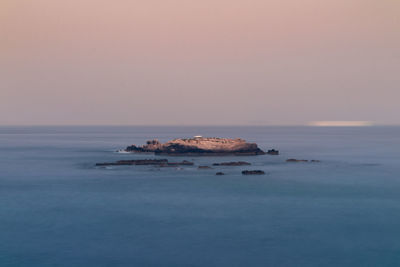 Scenic view of sea against clear sky during sunset