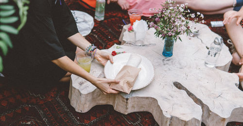 Midsection of woman holding food in plate