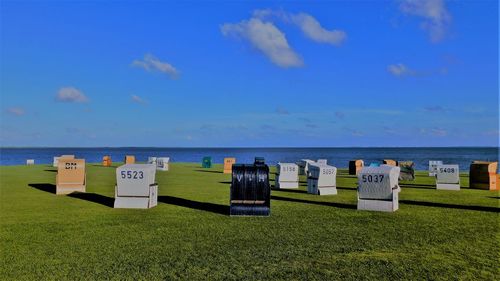 Hooded beach chairs at the coast of the north sea in büsumer deichhausen at a summers evening