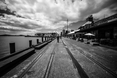 View of railroad tracks against cloudy sky