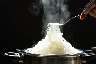 Glass noodles that just boiled in a basket from hot pot with steaming. hot food concept.