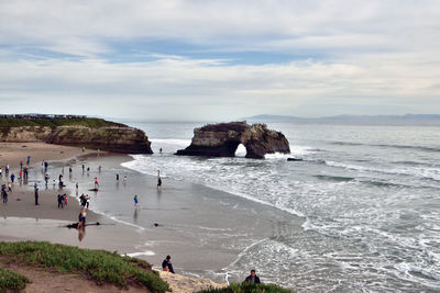 People on beach against sky