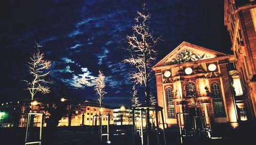 Low angle view of illuminated building against sky at night