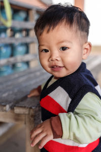 Portrait of cute baby boy standing at airport
