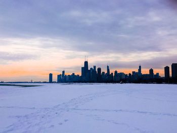 View of cityscape during winter against sky