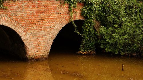 Arch bridge over wet wall