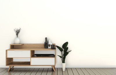 Empty chairs and table against white wall at home
