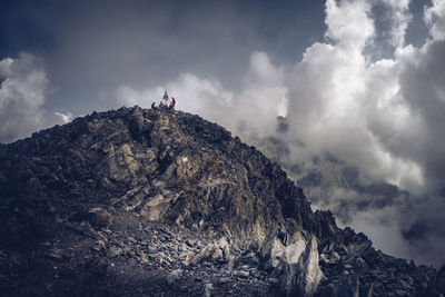 Hikers on the top of mountain peak italy alps