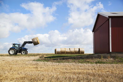 Tractor carry bale of hay